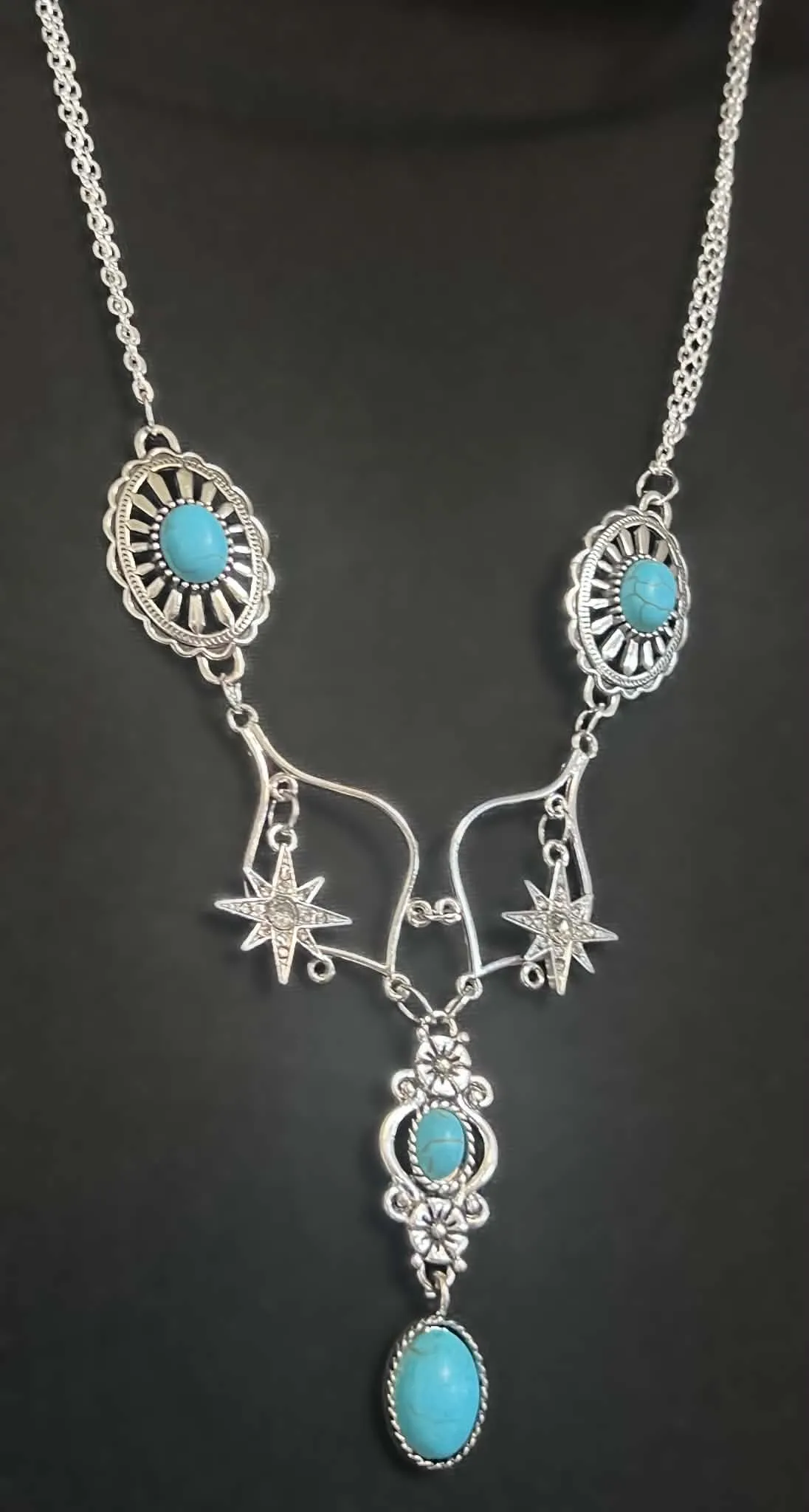 Turquoise star and concho necklace on a velvet bust